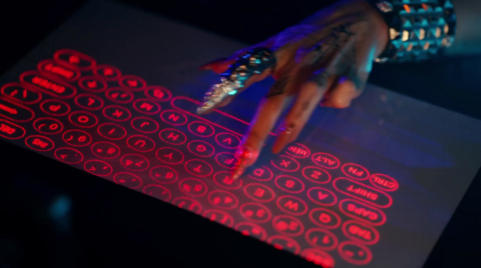 a person's hand on a keyboard with red lights