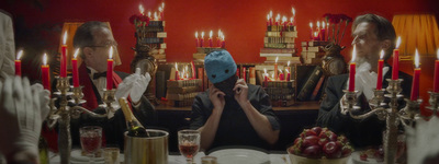 a man sitting at a table with a blue mask on