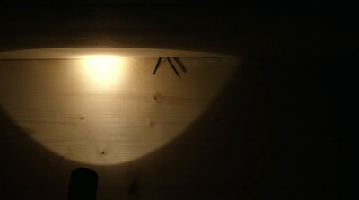 a wooden wall with a light shining on it