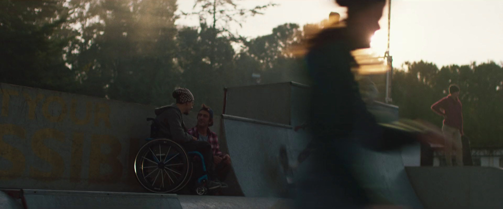 a man in a wheel chair on a skateboard ramp