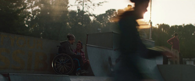 a man in a wheel chair on a skateboard ramp