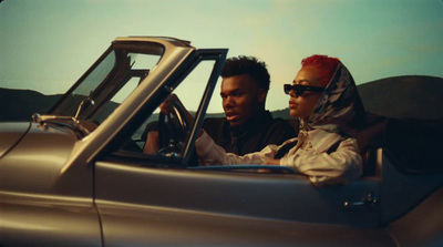 a man and a woman sitting in a car