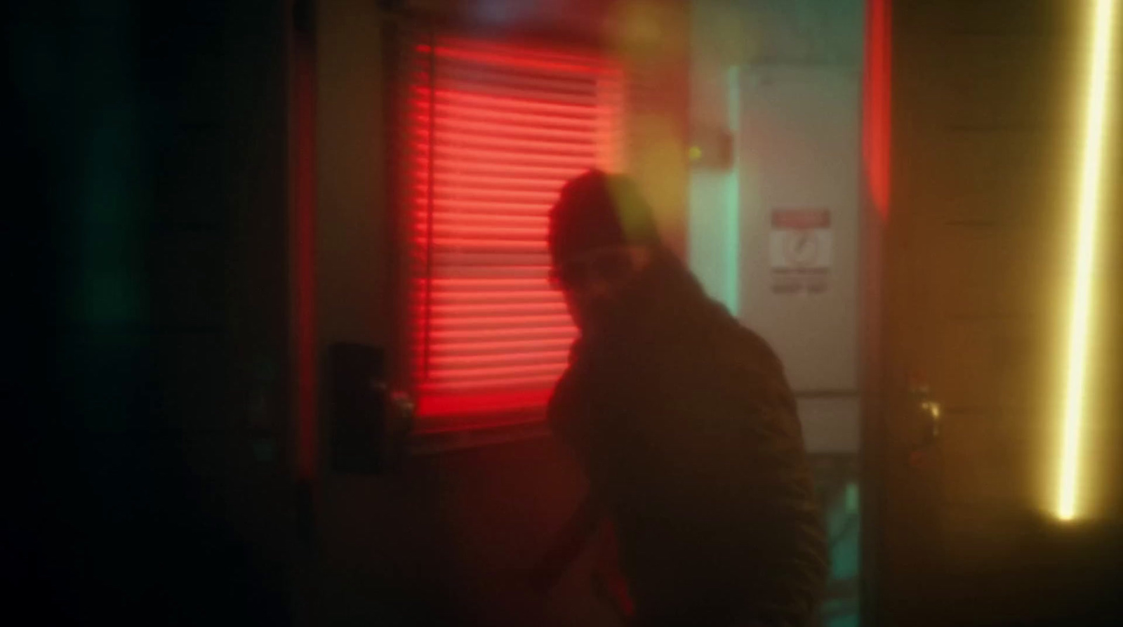 a blurry image of a person standing in front of a window