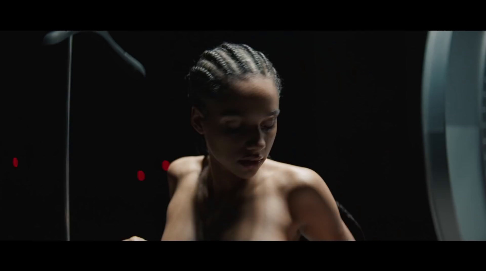 a woman with braids in a dark room