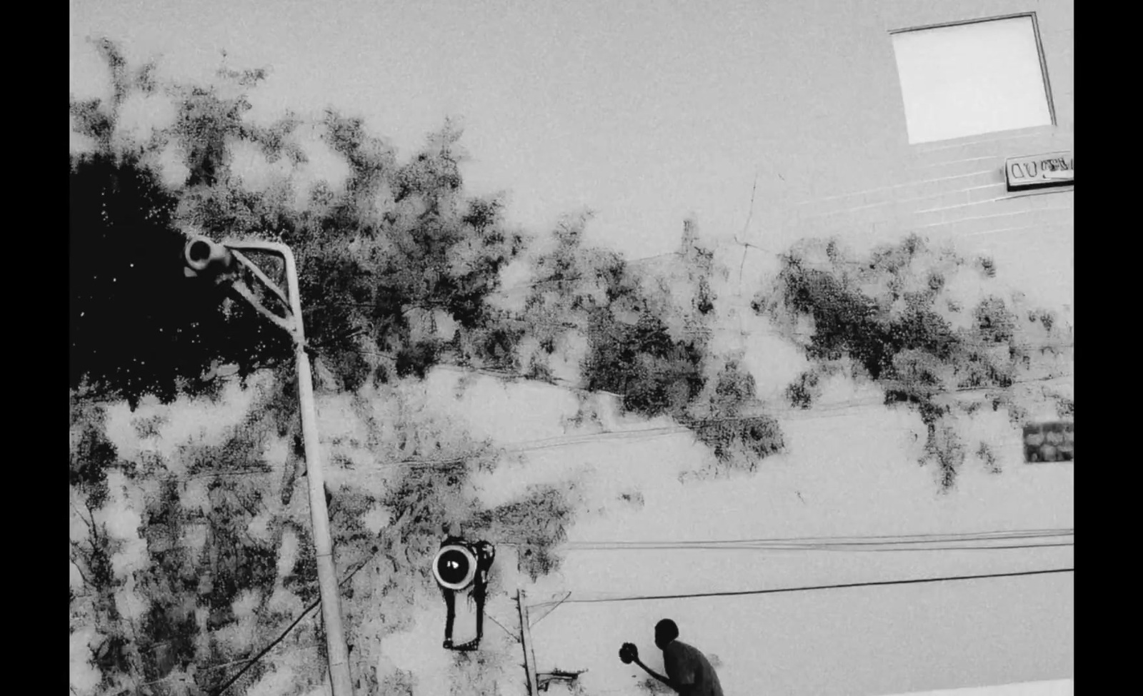 a black and white photo of a man on a snowboard