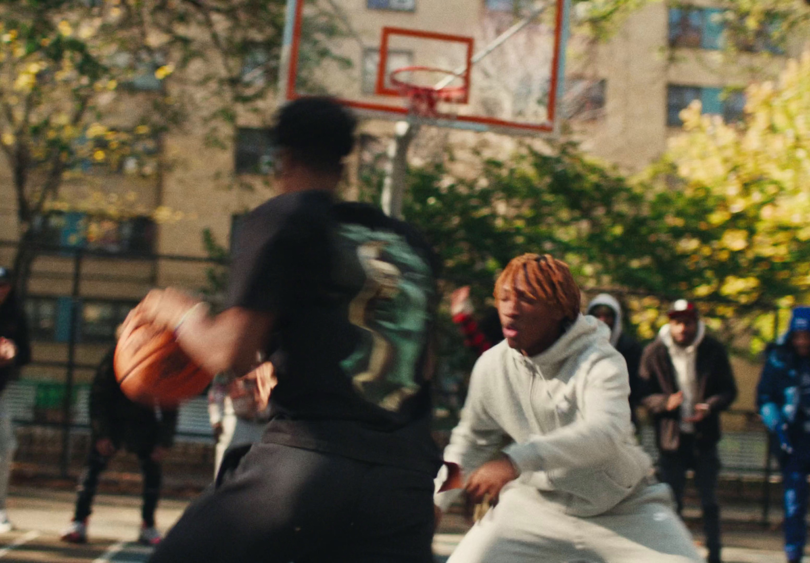 a group of young men playing a game of basketball