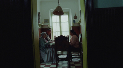 a couple of people sitting at a table in a room