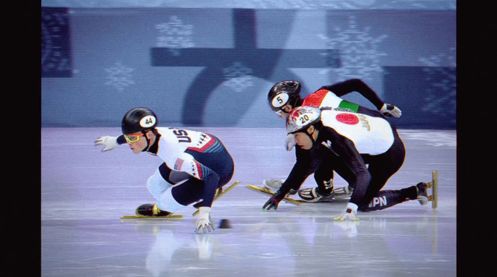 a group of people riding skates on top of a ice rink