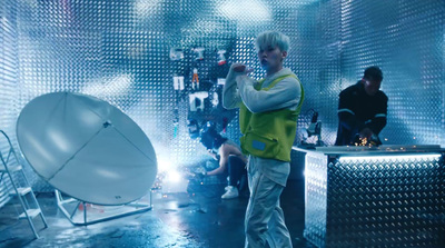 a man standing in front of a satellite dish