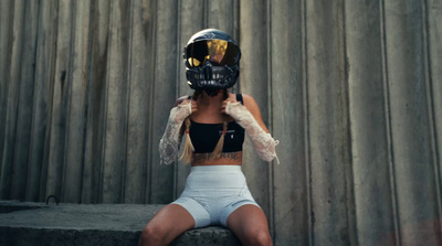 a woman wearing a mask sitting on a step