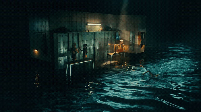 a group of people standing inside of a building in the water