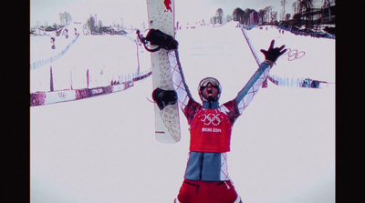 a man holding a snowboard up in the air