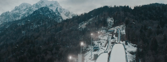 a snow covered mountain with a ski lift going up it's side