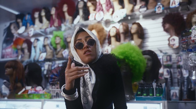 a woman wearing sunglasses and a scarf in a store