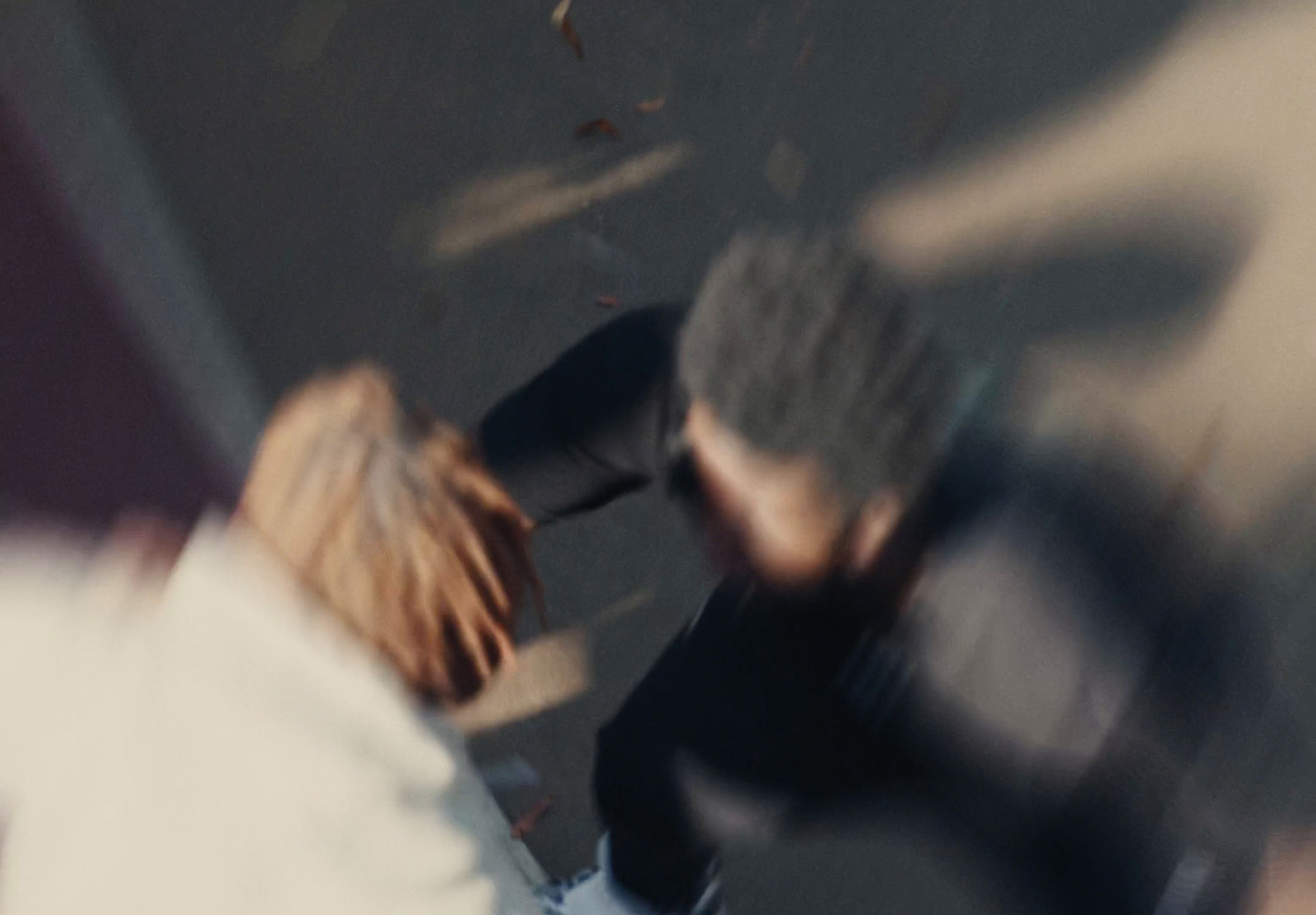 a blurry image of a man and a woman walking down a street