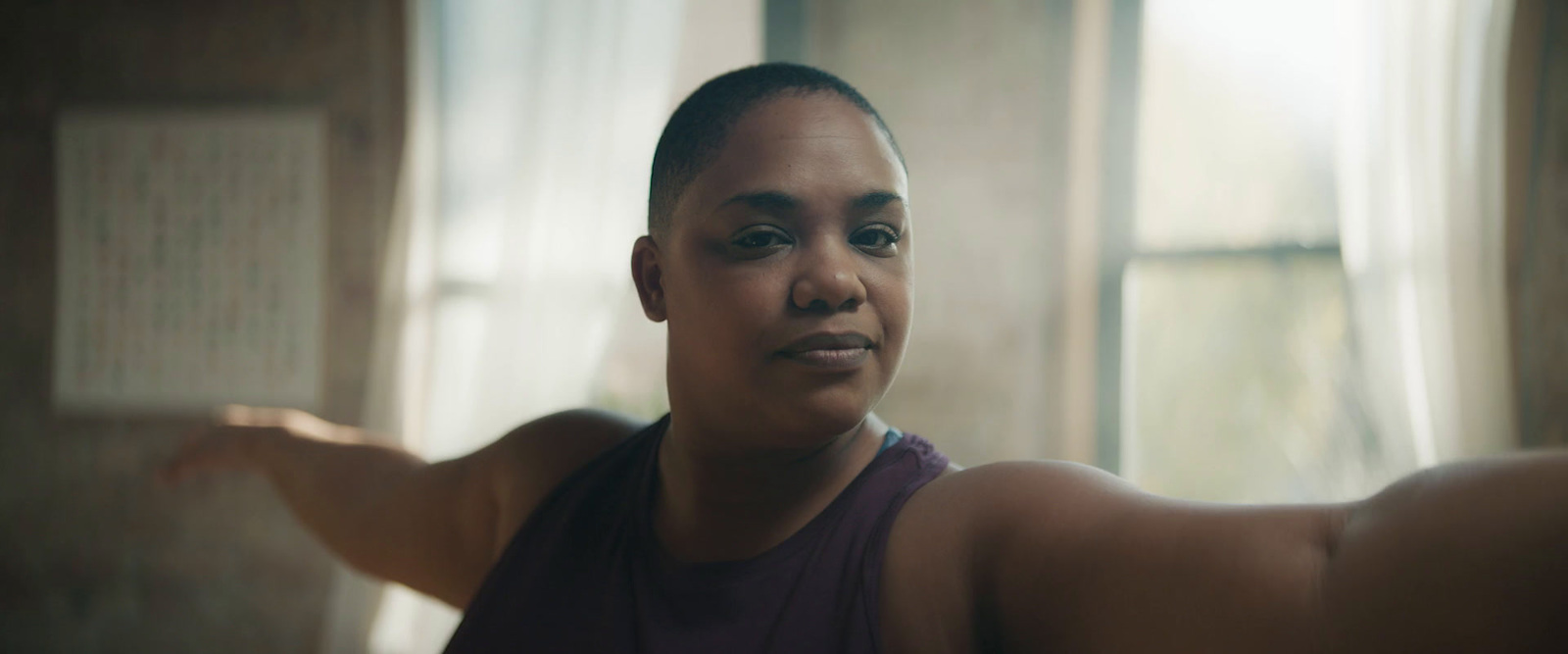 a woman in a tank top looking at the camera