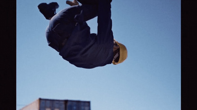 a man flying through the air while riding a skateboard