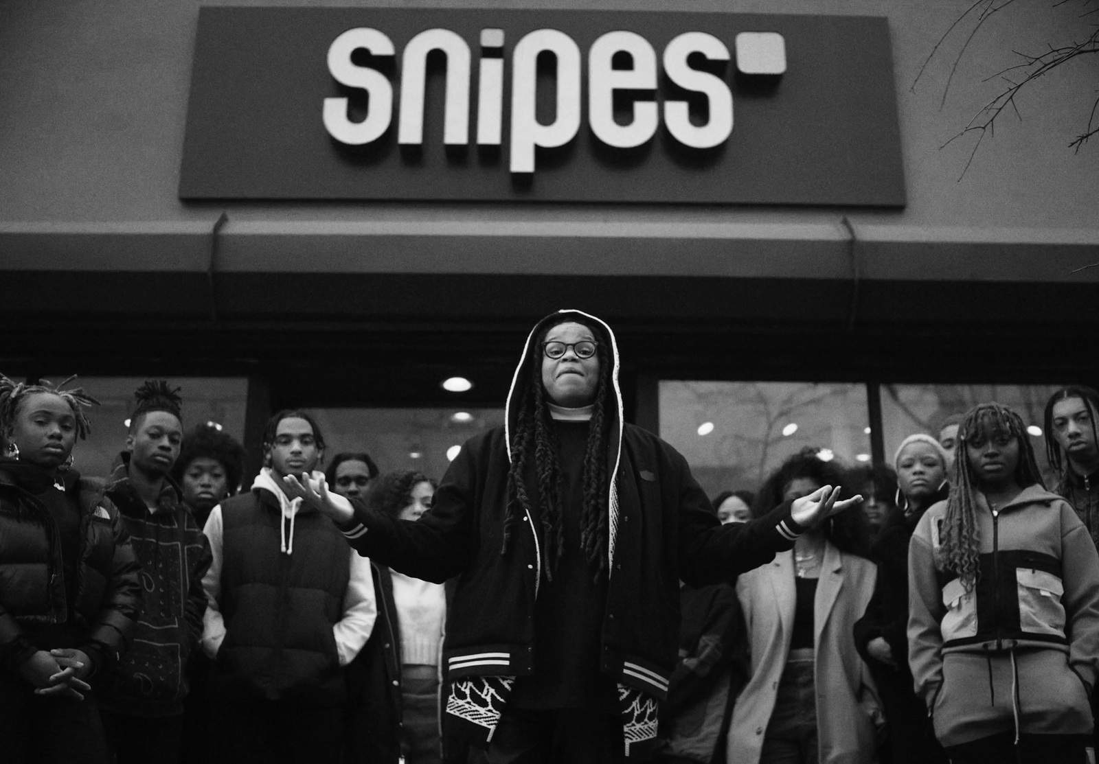 a group of people standing outside of a store