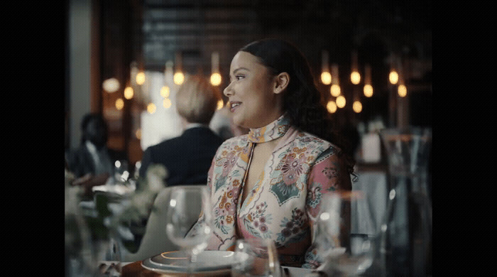 a woman sitting at a table in a restaurant