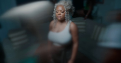 a blurry photo of a woman in a white top