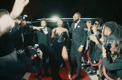 a group of people that are standing on a red carpet