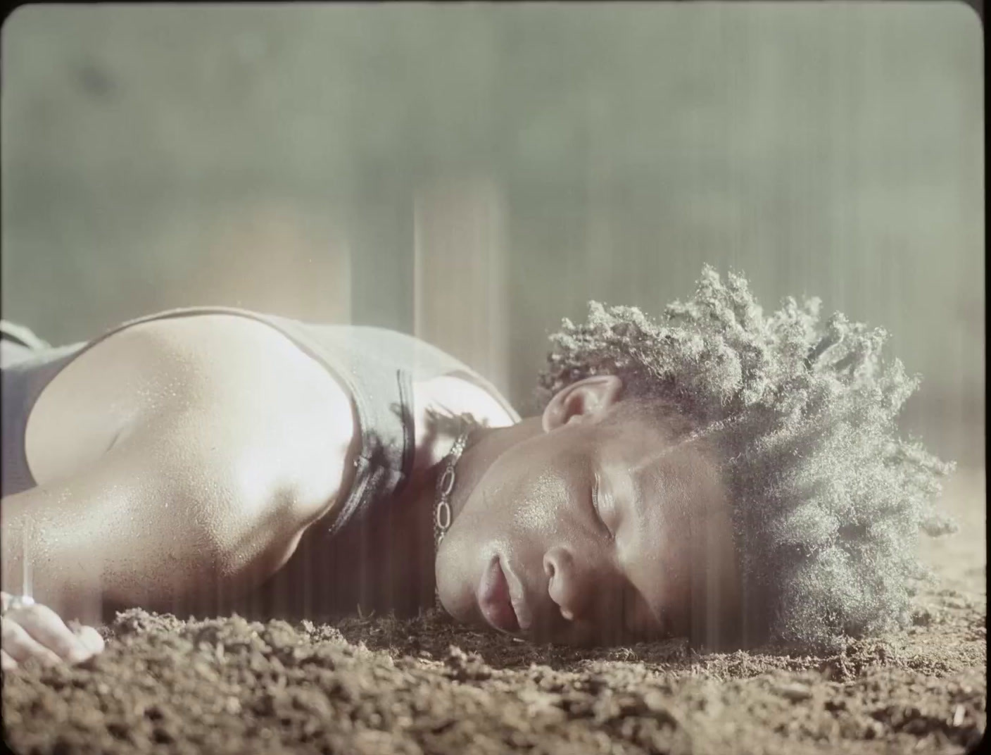 a woman laying on the ground with her eyes closed