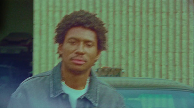 a man standing in front of a car in front of a building