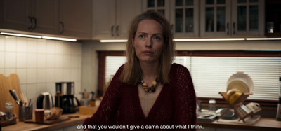 a woman standing in a kitchen next to a counter