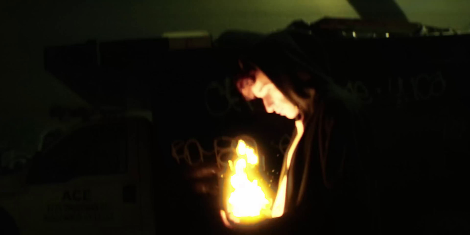 a woman holding a lit candle in her hands