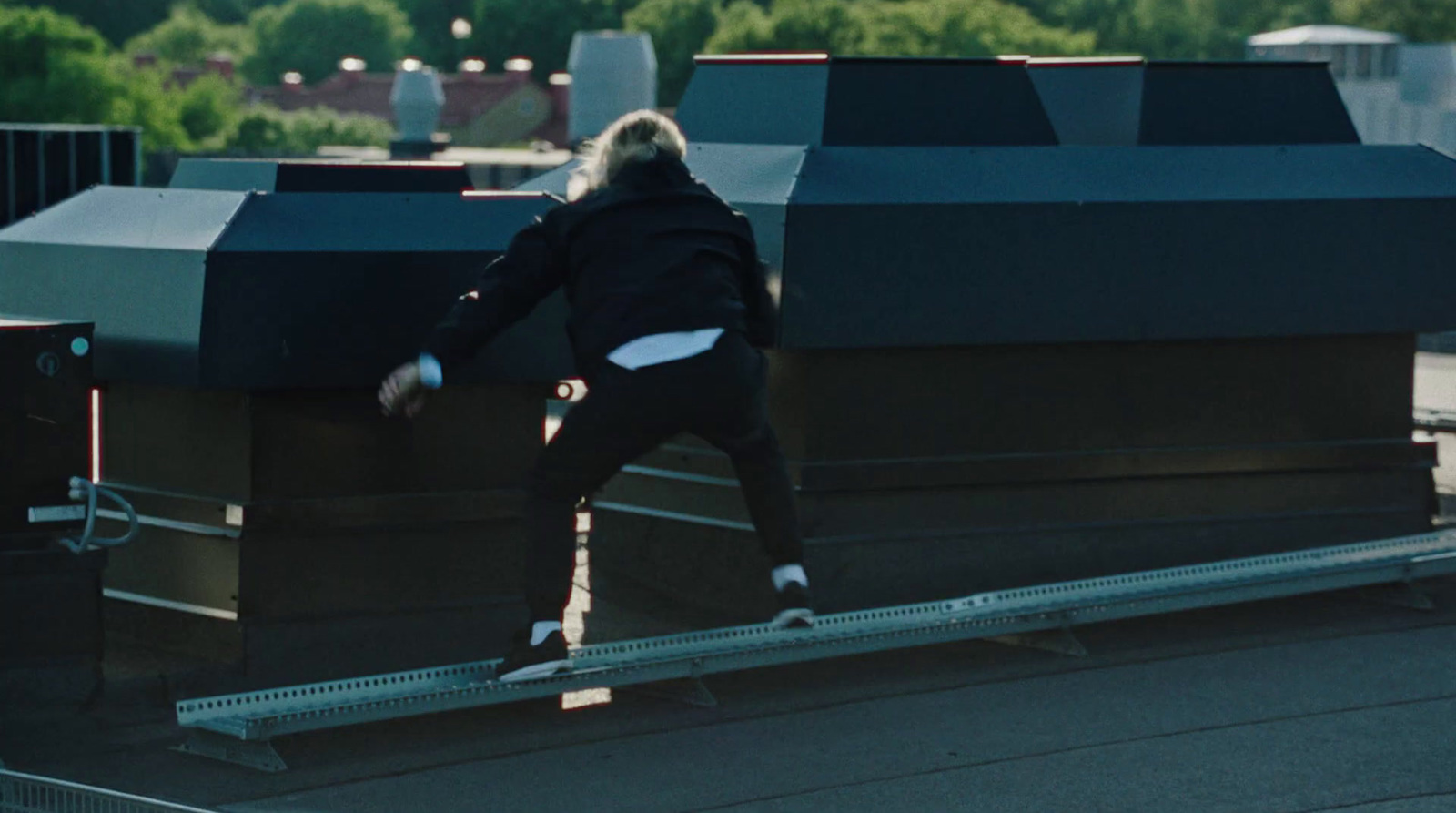 a man riding a skateboard down a metal rail