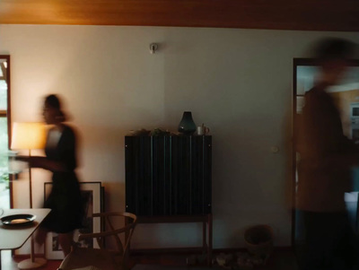 a blurry photo of a man and a woman in a living room