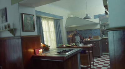 a woman standing in a kitchen next to a stove top oven