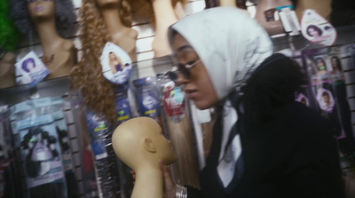 a woman looking at a mannequin's head in a store