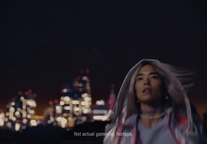 a woman standing in front of a city at night