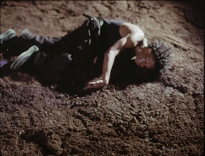 a man laying on the ground in the dirt