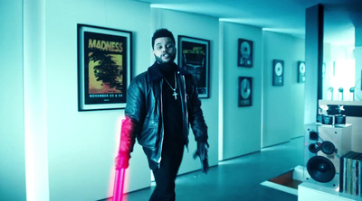 a man walking down a hallway holding a pink umbrella