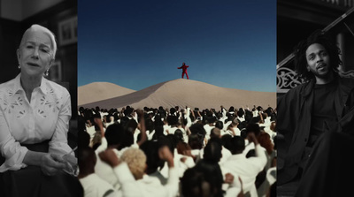 a man standing on top of a hill in front of a crowd of people