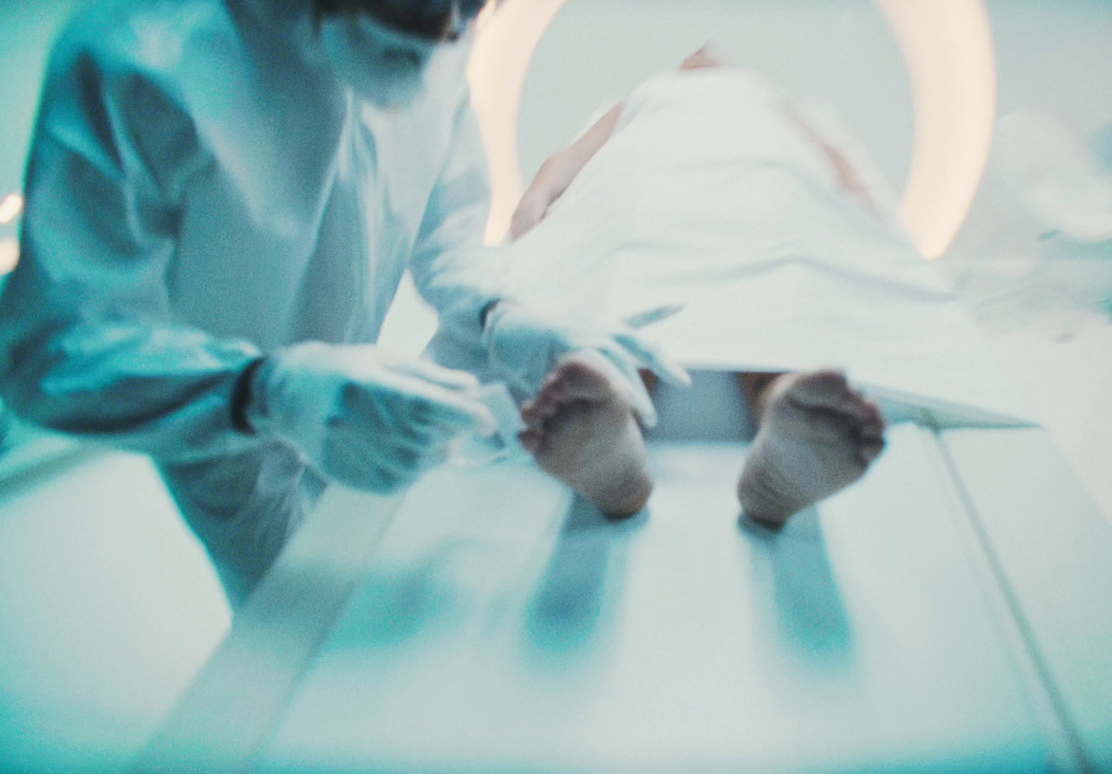 a person in a white suit is laying on a table