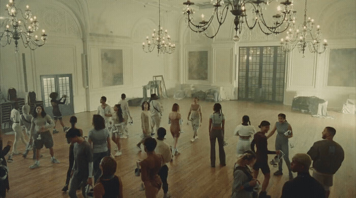 a group of people dancing in a large room