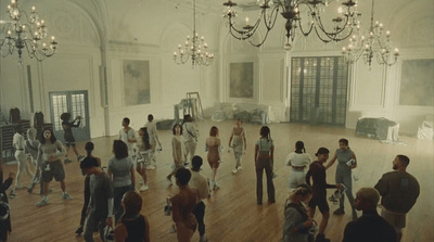 a group of people dancing in a large room