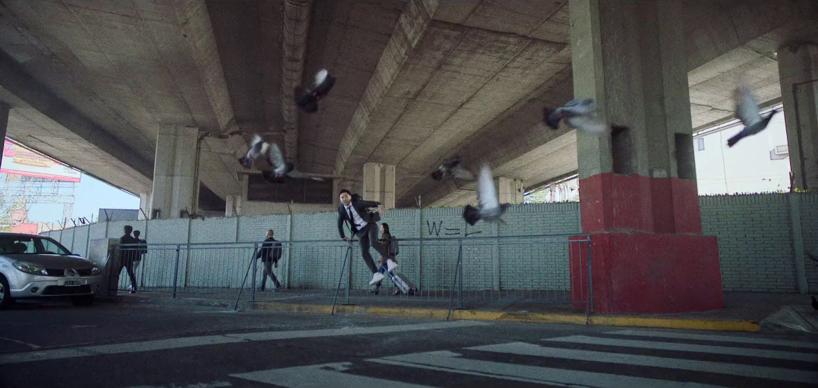 a group of people standing under a bridge