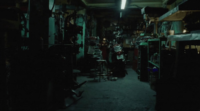 a dark room filled with lots of clutter