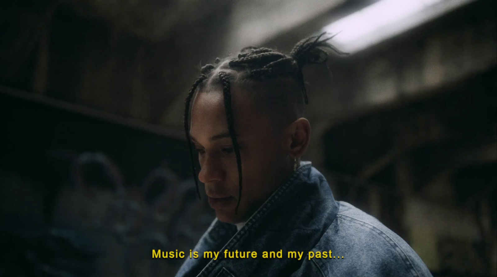 a man with dreadlocks standing in a room