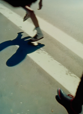 a person riding a skateboard down a street