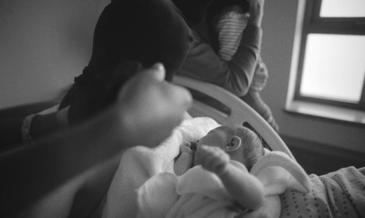 a black and white photo of a baby in a crib