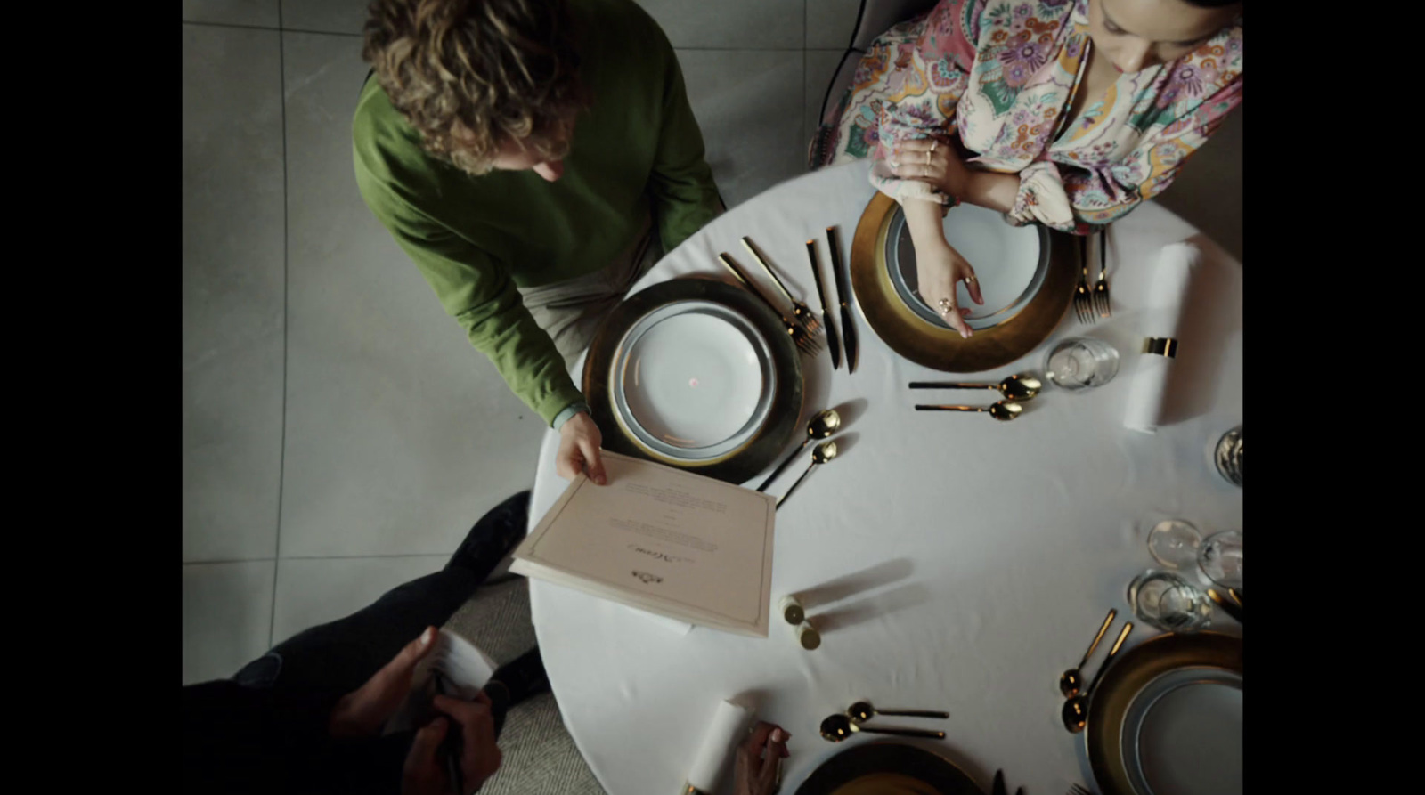 a group of people sitting around a white table