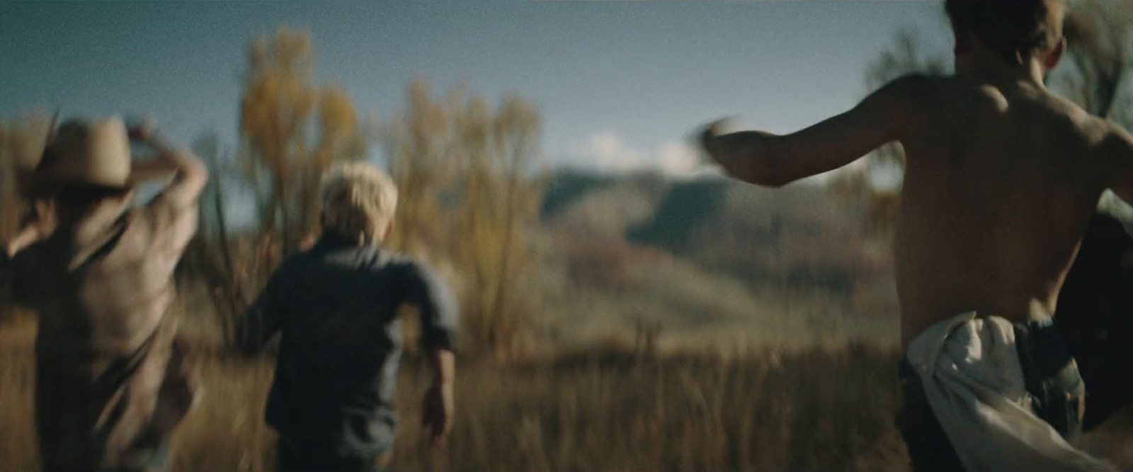 a group of young men playing a game of frisbee