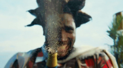 a man with a bottle of wine in his hand