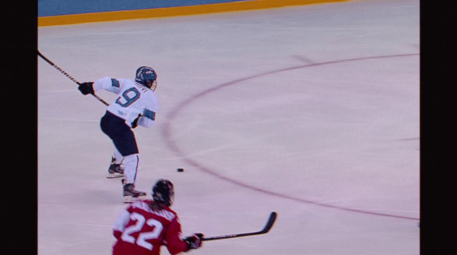 a couple of people playing a game of ice hockey