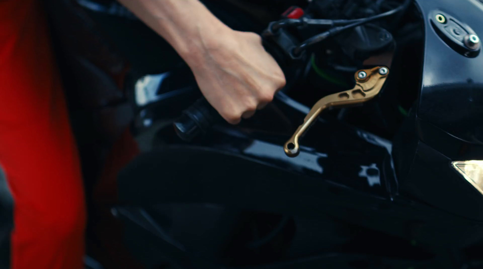 a close up of a person's hand on a motorcycle